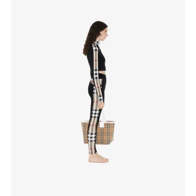 Bluză scurtă din jersey elastic cu fermoar și bordură în carouri Bluză scurtă din jersey elastic cu fermoar și bordură în carouri