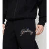 Pantaloni de jogging din bumbac cu logo cursiv în carouri